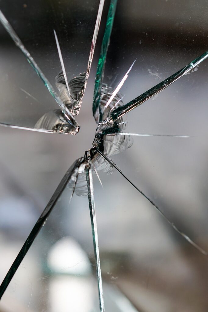 clear glass with a bullet hole in it